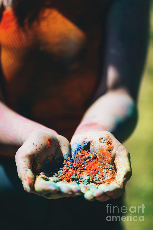 Woman holding colorful powder in her hands. Photograph by Michal Bednarek