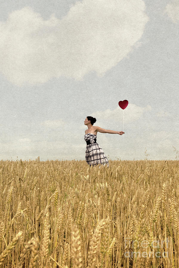 Woman in corn field with heart shaped balloon Photograph by Clayton Bastiani