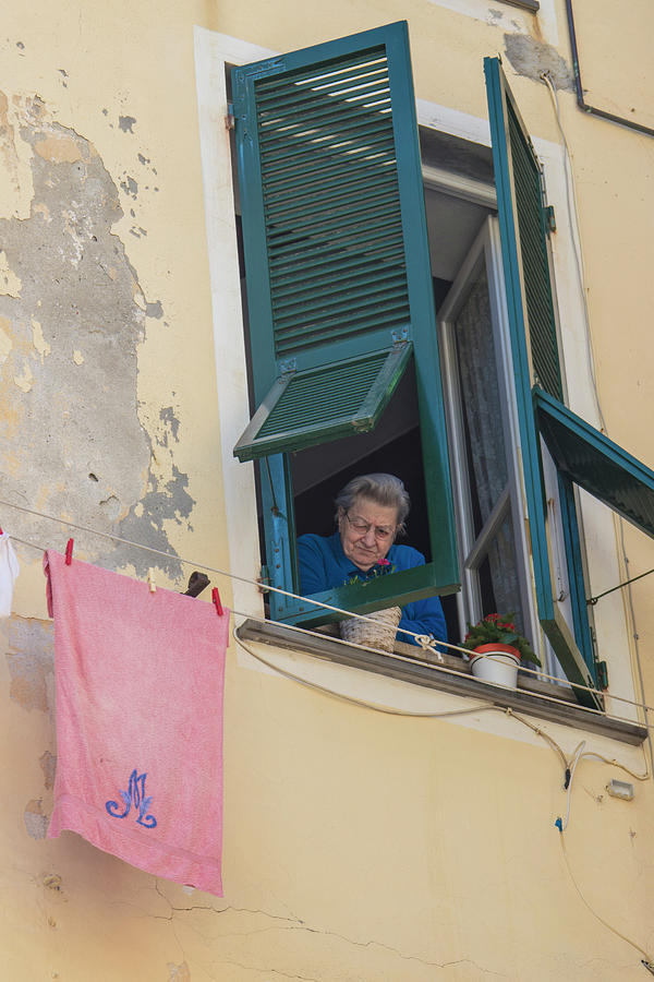 Woman in window Cinque Terre Photograph by John McGraw