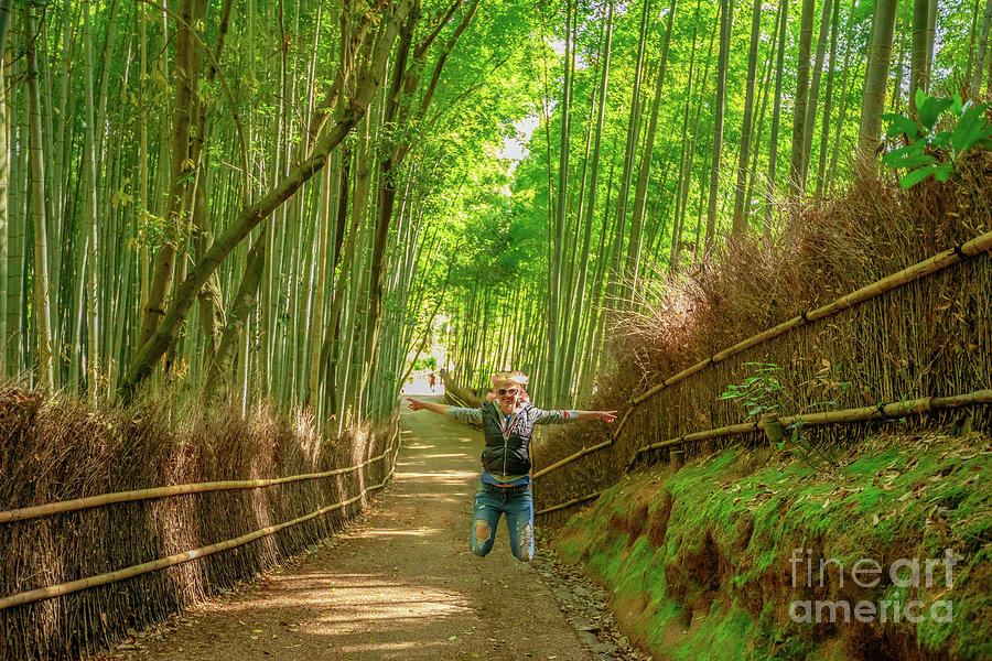 Woman jumping in Bamboo Forest Photograph by Benny Marty