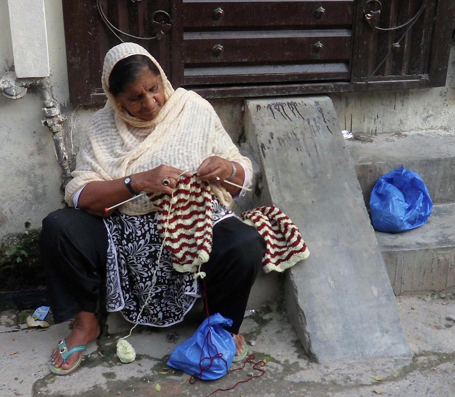 Pakistan Photograph - Woman Knitting Sweater by Bobby Dar