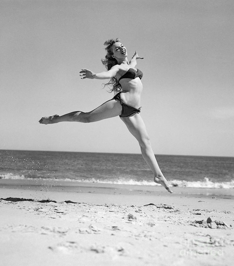 Woman Leaping On The Beach, C.1950s Photograph by H Armstrong Roberts and ClassicStock