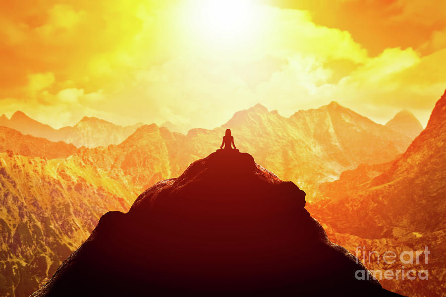 Woman meditating in sitting yoga position on the top of a mountains above clouds at sunset. Photograph by Michal Bednarek