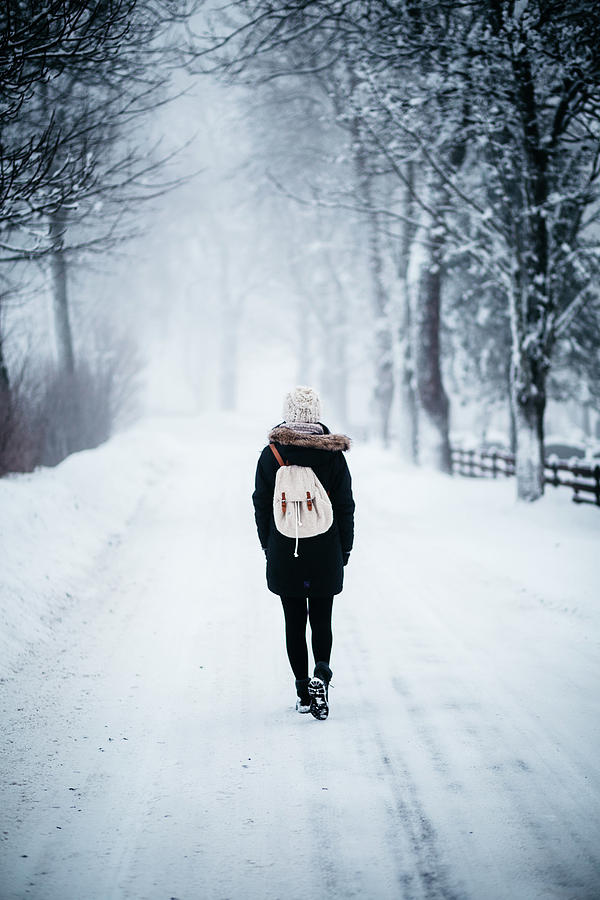 Woman on path with spooky trees in winter Photograph by Aldona Pivoriene