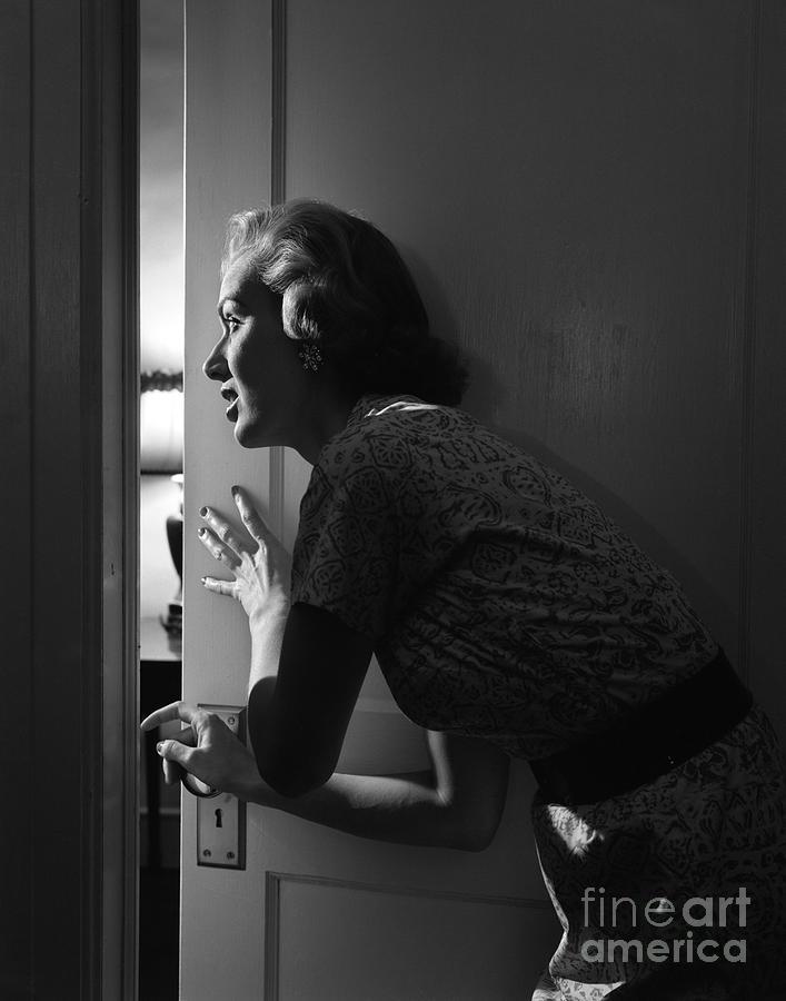 Woman Peeking Through Door, C.1950s Photograph by Debrocke/ClassicStock