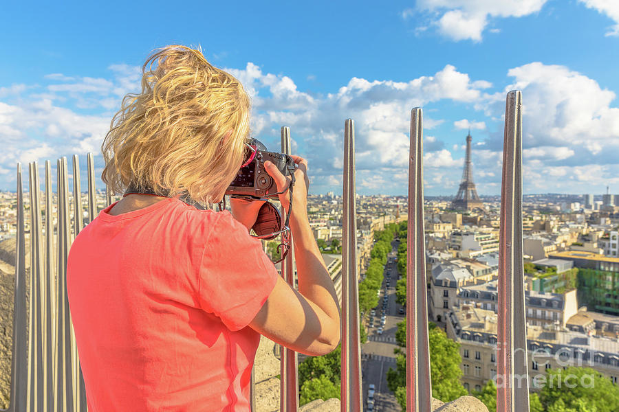Woman photographs Eiffel Tower Photograph by Benny Marty