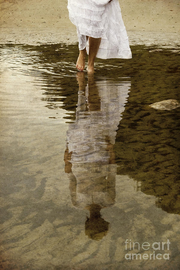 Woman reflected in puddle Photograph by Clayton Bastiani