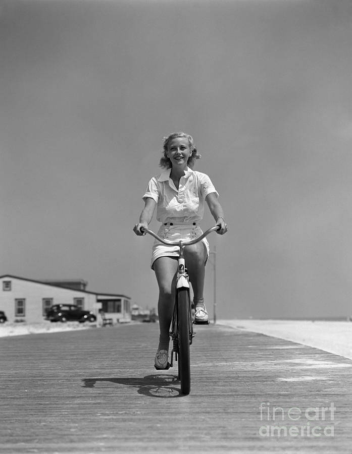 Woman Riding Bike On Boardwalk, C.1940s Photograph by H. Armstrong Roberts/ClassicStock