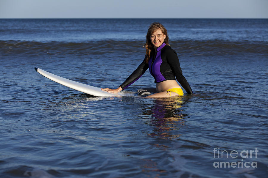 Woman sitting on white surfboard in the ocean Photograph by Anthony Totah