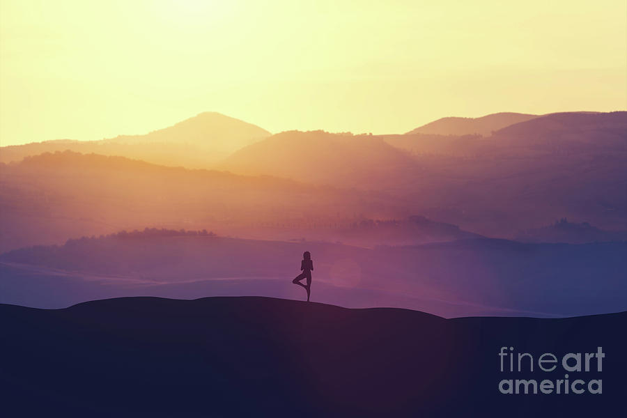 Woman standing on the hill, practicing yoga. Photograph by Michal Bednarek