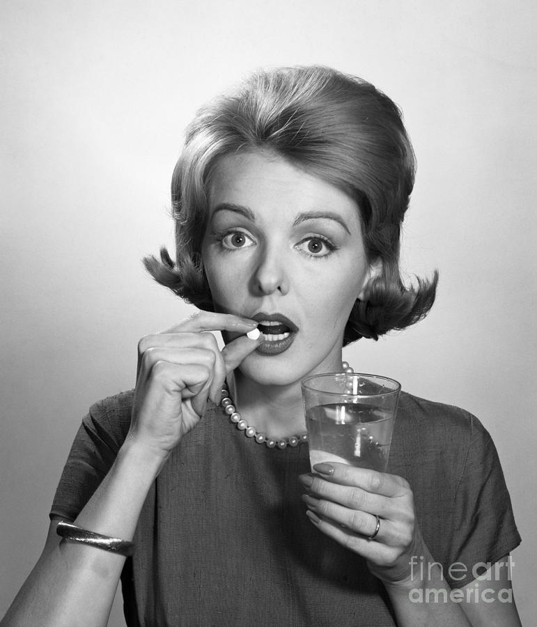 Woman Taking An Aspirin Pill Photograph by Debrocke/ClassicStock