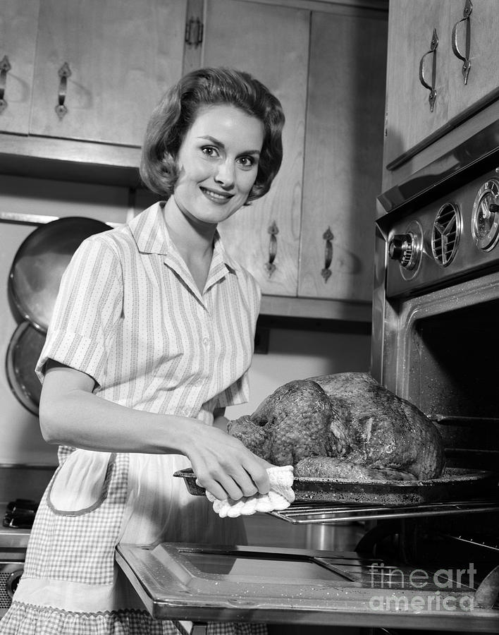 Woman Taking Turkey From Oven, C.1960s Photograph by H. Armstrong Roberts/ClassicStock