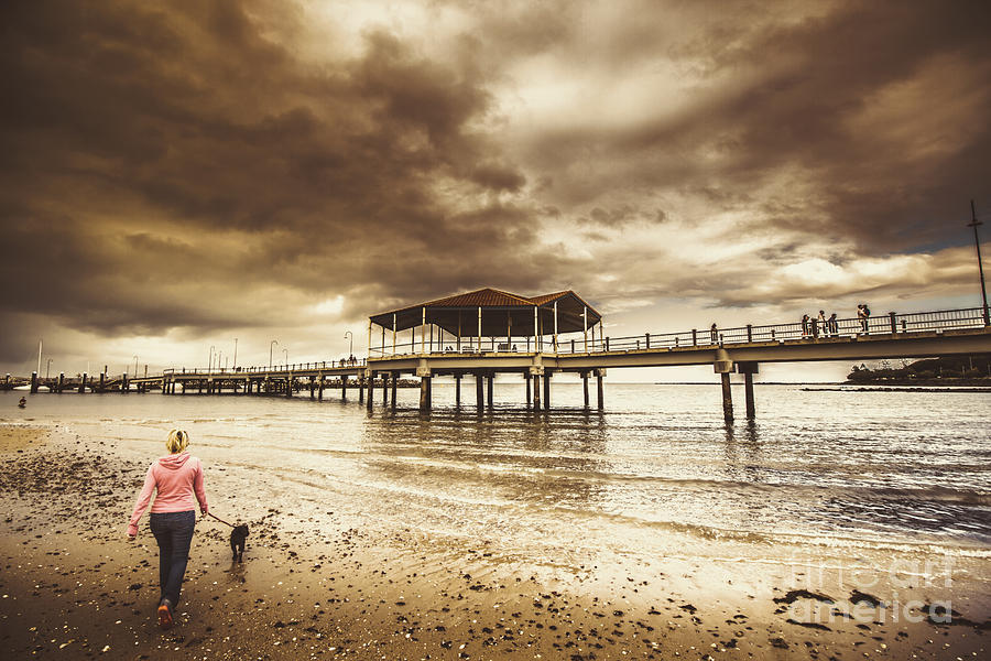 Woman walking dog on stormy beach Photograph by Jorgo Photography
