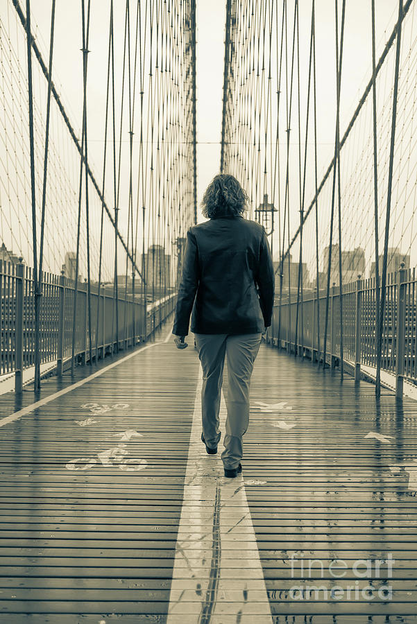 Woman walking on the Brooklyn Bridge Photograph by Edward Fielding