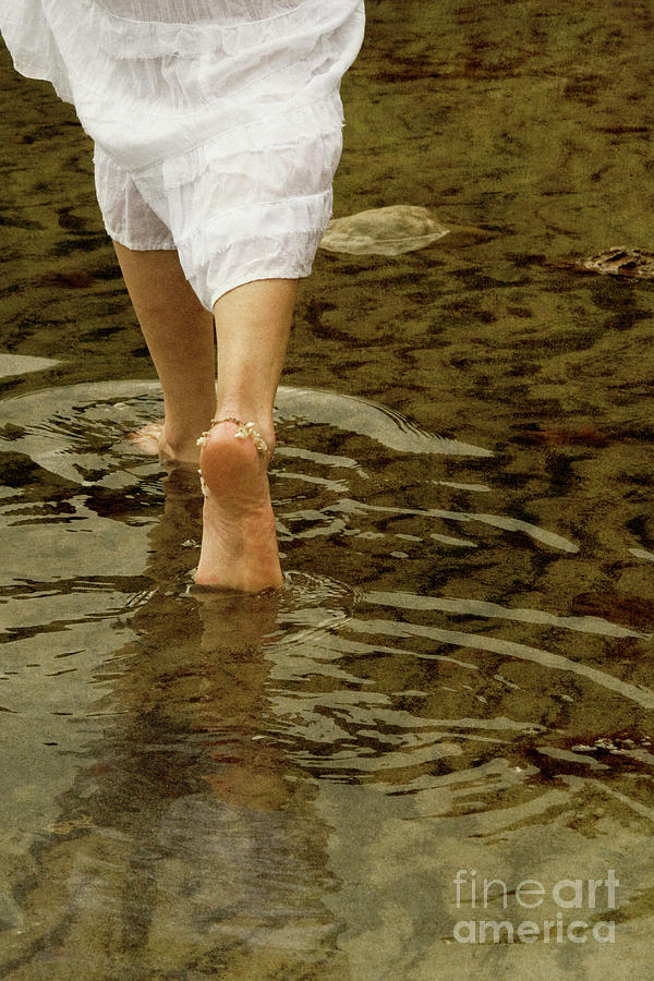 Woman walking through water Photograph by Clayton Bastiani