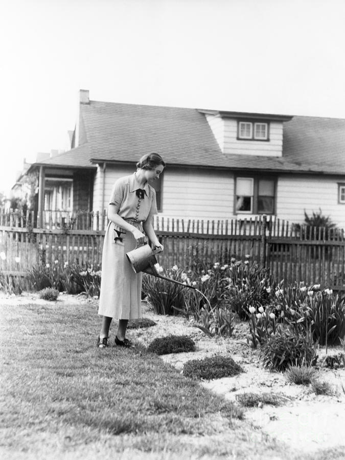 Woman Watering Garden, C.1930s Photograph by H. Armstrong Roberts/ClassicStock