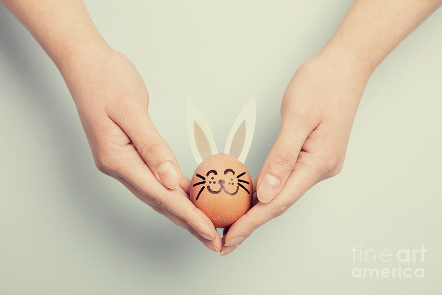 Womans hand holding an Easter bunny Photograph by Michal Bednarek