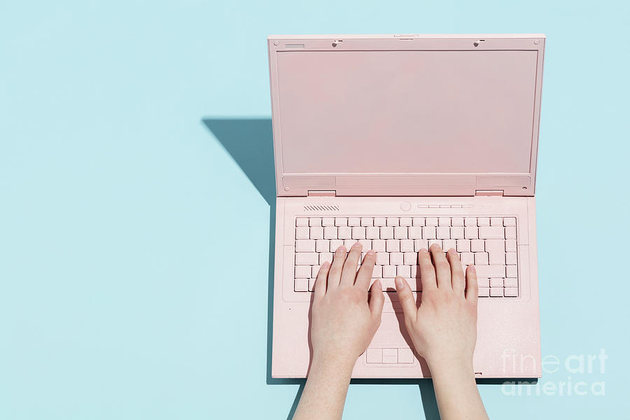 Womans hands typing on a pastel pink keyboard Photograph by Michal Bednarek