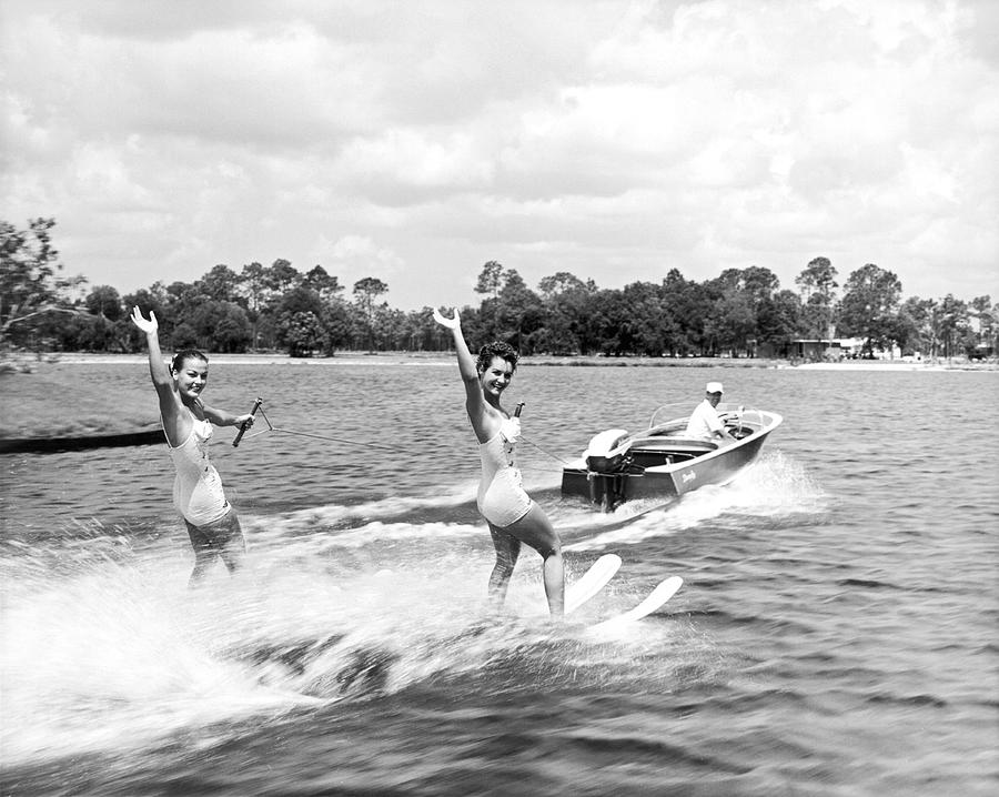 Women Water Skiers Waving Photograph by Underwood Archives