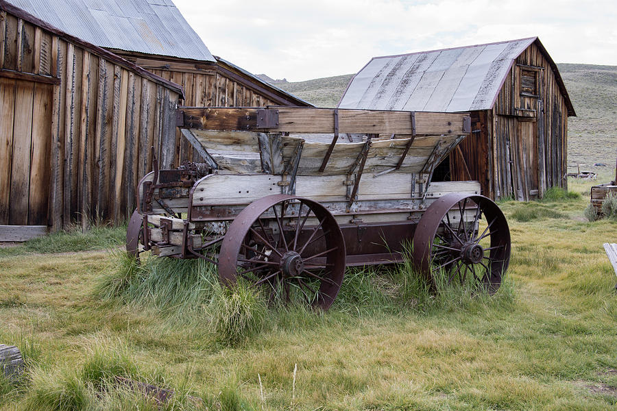 Wooden cart in barn yard of Bodie, California Photograph by Karen Foley