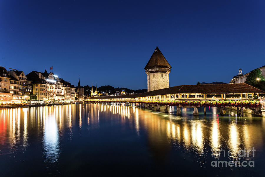 Wooden Chapel bridge at night in Lucerne.  Photograph by Didier Marti