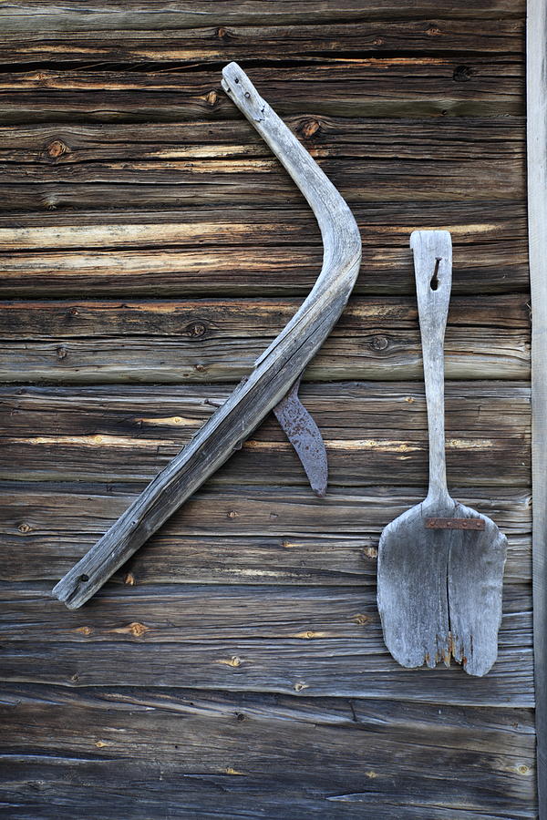 Wooden hand plow and shovel on a log house wall Photograph by Ulrich Kunst And Bettina Scheidulin