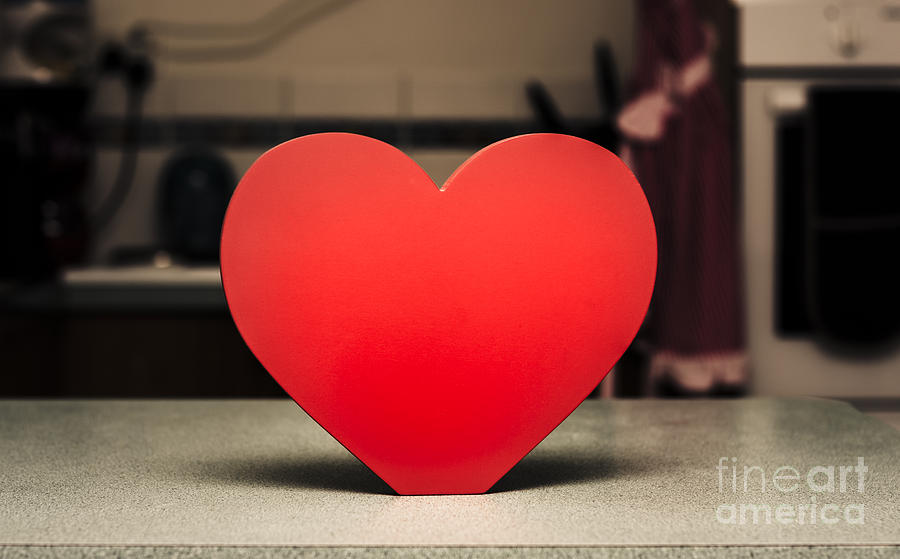 Wooden heart shape chopping block on kitchen bench Photograph by Jorgo Photography