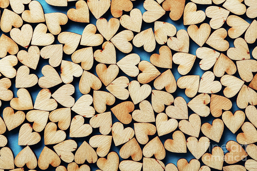 Wooden hearts on blue background. Photograph by Michal Bednarek