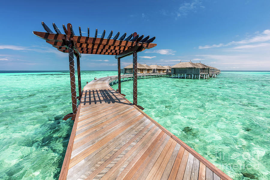 Wooden jetty towards water villas in Maldives. Photograph by Michal Bednarek