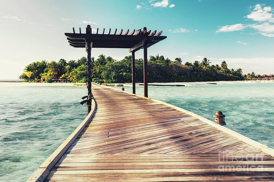 Wooden jetty with arch leading to a tropical island Photograph by Michal Bednarek