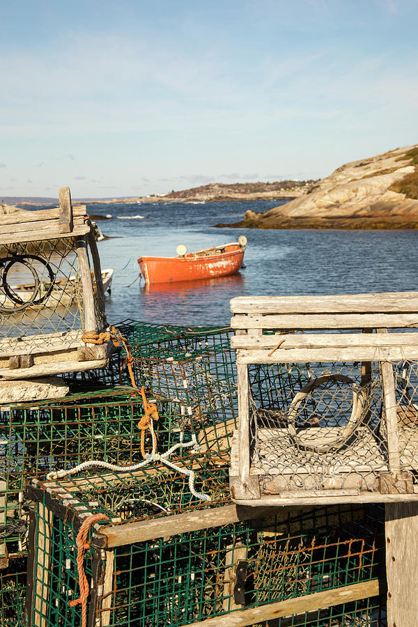 Wooden lobster traps on dock in Peggys Cove, Nova Scotia, Canada Photograph by Karen Foley
