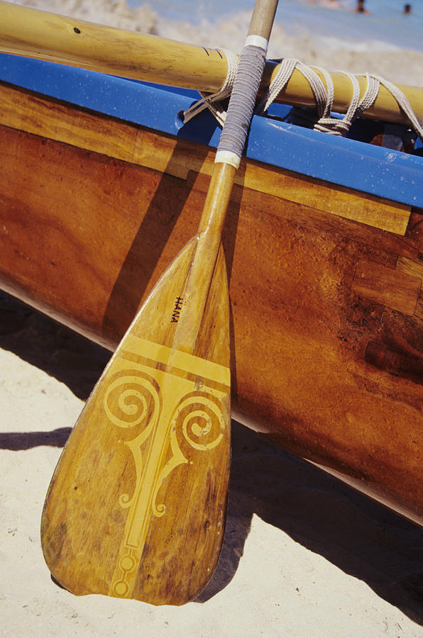 Wooden Paddle And Canoe Photograph by Joss - Printscapes