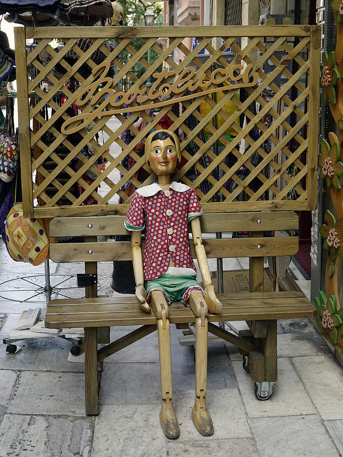 Wooden Pinocchio Doll Sitting On A Bench In Athens Greece Photograph