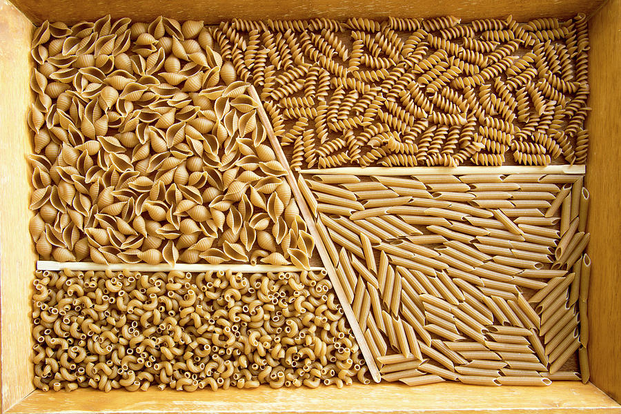 Wooden tray with assorted whole wheat pasta  Photograph by Karen Foley