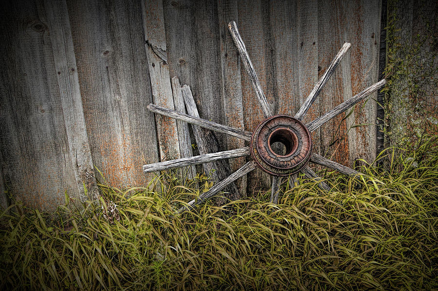 Wooden Wagon Wheel Spokes against wood Barn siding Photograph by Randall Nyhof