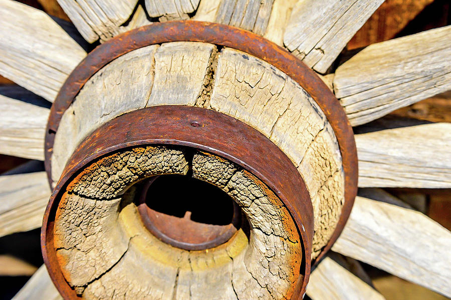 Wooden wheel hub Photograph by Kathleen Maconachy