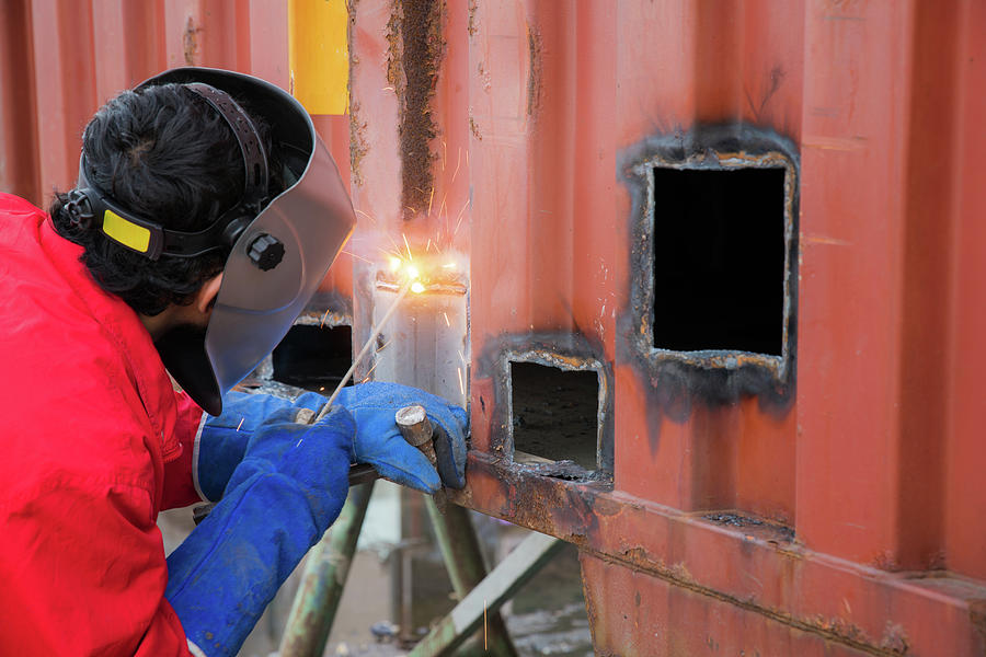 Worker repair container box by gas cutting and welding Photograph by Anek Suwannaphoom