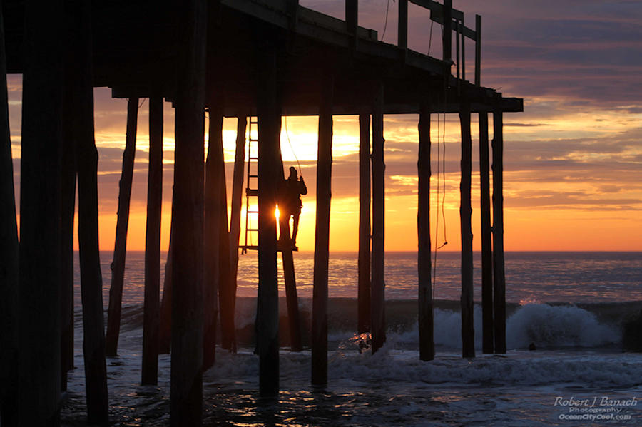 Working On The Pier At Dawn Photograph by Robert Banach