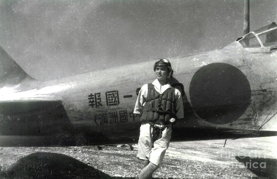 World War II,Japanese pilot poses by Zero fighter in the South Pacific Photograph by Japanese School
