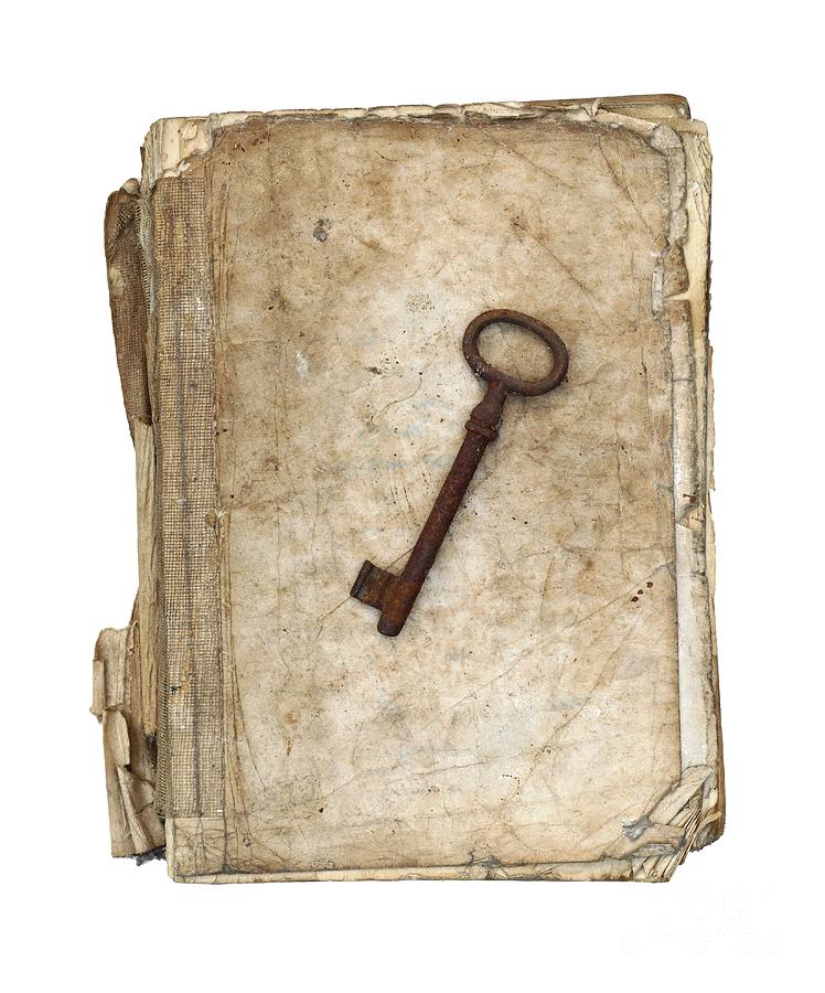 Worn and tattered book and old rusty key Photograph by Michal Boubin