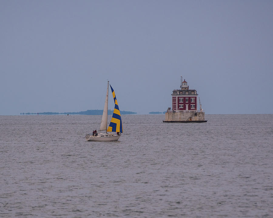 Yellow and Blue sailboat passing by the New London Ledge Lighthouse CT Connecticut Photograph by Toby McGuire
