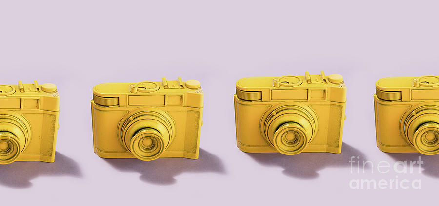 Yellow cameras standing in a row Photograph by Michal Bednarek