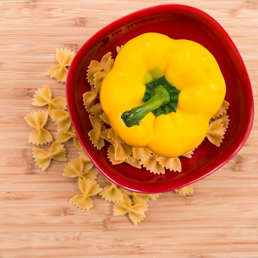 Bowl Photograph - Yellow Pepper in Red Bowl with Pasta by Rebecca Cozart