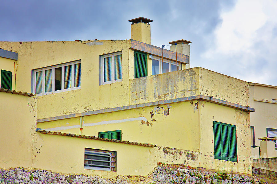 Yellow worn out concrete house Photograph by Jan Brons