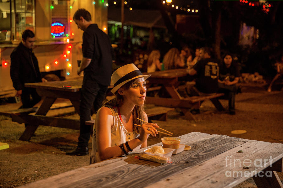 Austin Photograph - Young attractive Austin local eats at an East Austin food trailer park by Dan Herron