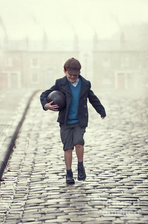 Young Boy Carrying A Vintage Leather Football Ona 1940s Cobbled  Photograph by Lee Avison