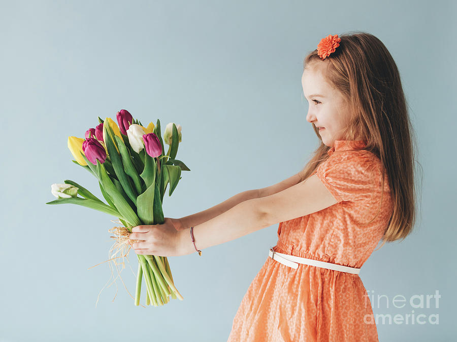 Young child holding a bunch of fresh flowers Photograph by Michal Bednarek