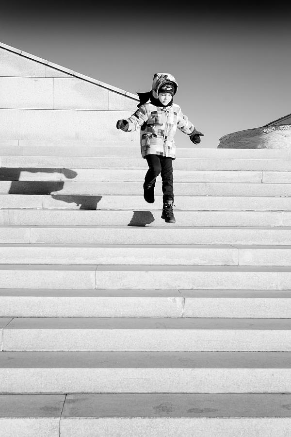 Young Child Jumping Down Steps Photograph by John Williams