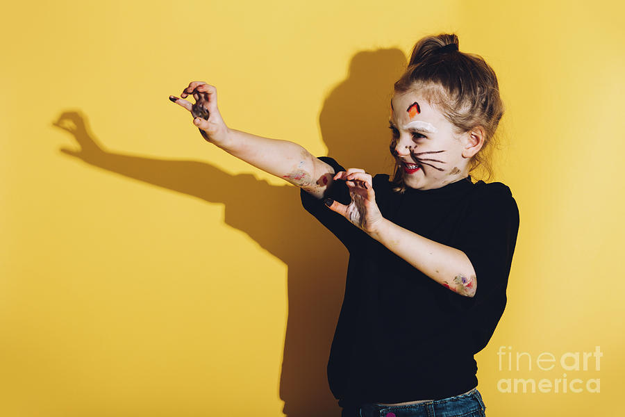Young child with cat make up streching her hands Photograph by Michal Bednarek