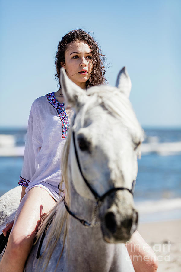 Young girl sitting on a white horse on the seashore Photograph by Michal Bednarek